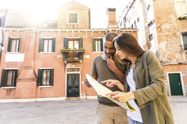 Italy, Venice, young couple looking at map in the city - WPEF01239