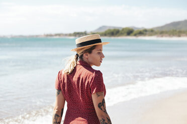 Spain, Mallorca, pensive young woman with tattoos on the beach - LOTF00015