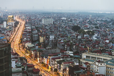 Vietnam, Hanoi, panoramic view of the city at dusk, with illuminated main road and dark residential areas - WPEF01275