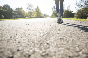 Close-up of running woman on footpath - CHPF00529