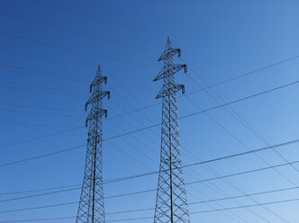 Power pylons under blue sky - WWF04759