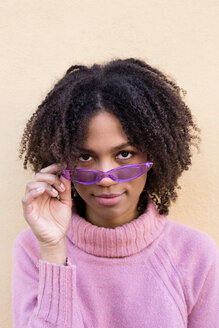 Portrait of young woman wearing pink turtleneck pullover and purple sunglasses - LOTF00043