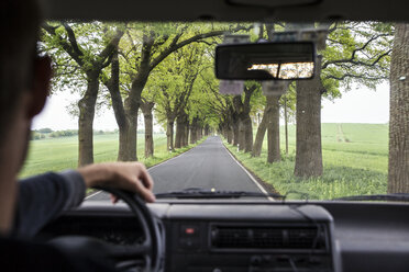 Germany, Ruegen, man driving car on an alley - MAMF00305