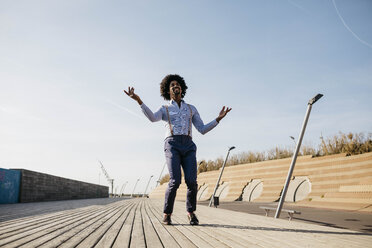 Man dancing on boardwalk - JRFF02419