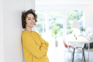 Portrait of woman leaning against a wall at home - JOSF02690