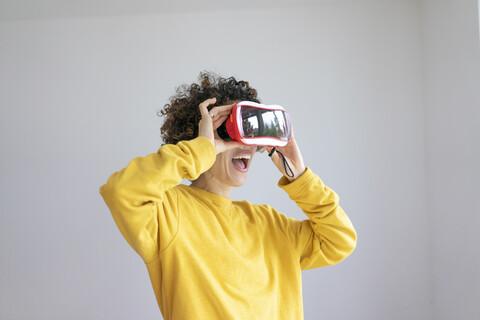 Excited woman wearing VR glasses stock photo