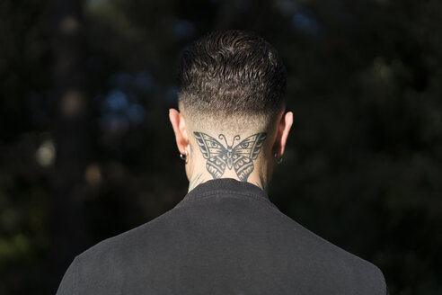 Back view of man with tattooed butterfly on his neck - XCF00182