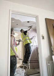Construction workers plastering ceiling in house - HOXF04262