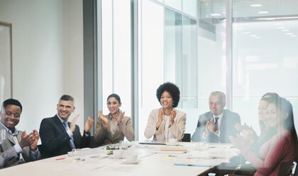 Happy, supportive business people clapping in conference room meeting - HOXF04321