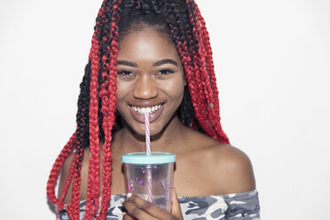Portrait smiling, confident teenage girl drinking smoothie - CAIF22429