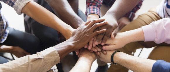 Men joining hands in group therapy - CAIF22517