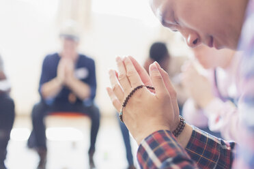Mann betet mit Gebetsperlen in einer Gebetsgruppe - CAIF22538