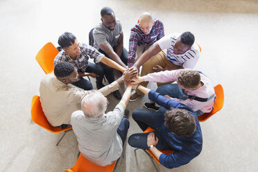 Men joining hands in circle in prayer group - CAIF22587