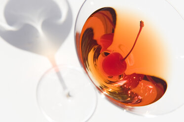 A closeup of a Manhattan cocktail served in a martini glass. - MINF09917