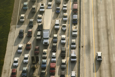 View of cars on a freeway in the evening rush hour, and one car on the opposite carriageway. - MINF09947