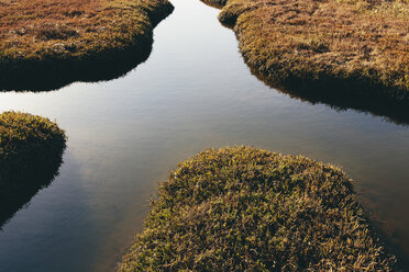 Intertidal wetlands and water channels, overhead view at sunset, reflected light in the water. - MINF10047