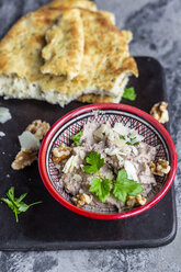 Bowl of homemade aubergine cream with walnuts, parmesan and parsley served with pita bread - SARF04046