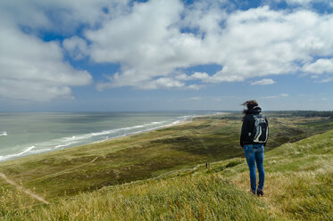 Denmark, Jutland, woman standing in dune landscape - UMF00876