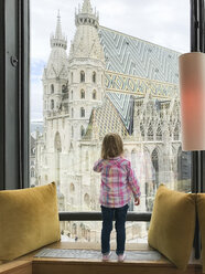 Österreich, Wien, Mädchen schaut aus dem Fenster Richtung Stephansdom - PSIF00201