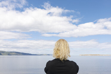 Woman by sea in Cromarty, Scotland - FOLF09632