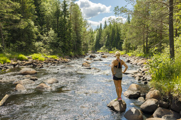 Woman on riverbank in Syssleback, Sweden - FOLF09641