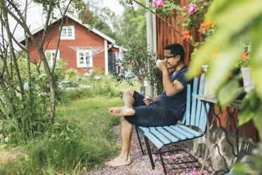 Man drinking a coffee outside in Mortfors, Sweden - FOLF09767