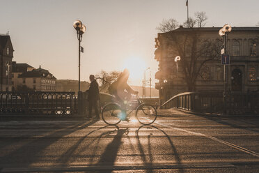 Man bicycling at sunset in Stockholm, Sweden - FOLF09781