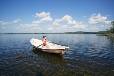 Mid adult woman rowing a boat in a lake in Finland - FOLF09840