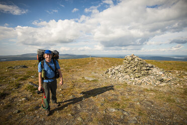 Man standing on top of a hill at Pallas-Yllastunturi National Park in Lapland, Sweden - FOLF09861