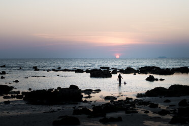 People swim on a beach at sunset on Peter Island in the Caribbean - FOLF09883