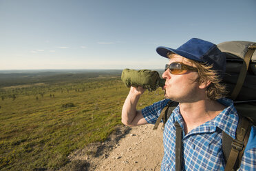 Man drinking from a bottle at the Pallas-Yllastunturi National Park in Lapland, Finland - FOLF09885