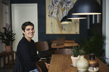 Young man sitting in a cafe in Copenhagen, Denmark - FOLF09944