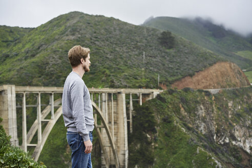 Mann vor einer Brücke und Bergen in Big Sur in Kalifornien, USA - FOLF10117