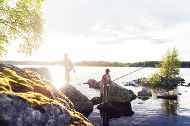 Friends fishing on a lake in Dalarna, Sweden - FOLF10174