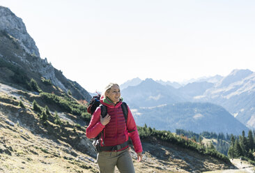 Austria, Tyrol, smiling woman on a hiking trip in the mountains - UUF16338