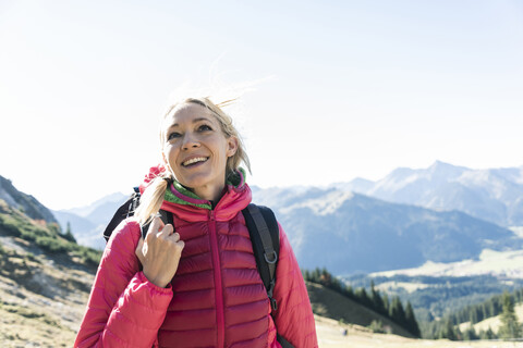 Austria, Tyrol, happy woman on a hiking trip in the mountains stock photo