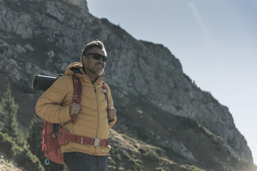 Österreich, Tirol, lächelnder Mann mit Sonnenbrille beim Wandern in den Bergen - UUF16353