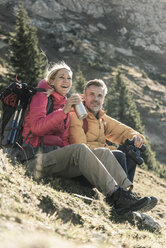 Austria, Tyrol, happy couple having a break during a hiking trip in the mountains - UUF16357