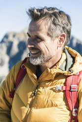 Austria, Tyrol, portrait of smiling man on a hiking trip in the mountains - UUF16373