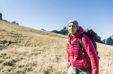 Austria, Tyrol, smiling woman on a hiking trip in the mountains - UUF16385