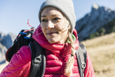 Portrait of happy young woman hiking in the mountains Stock Photo