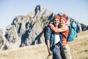 Austria, Tyrol, happy couple hugging on a hiking trip in the mountains - UUF16405