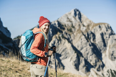 Austria, Tyrol, smiling woman on a hiking trip in the mountains - UUF16408