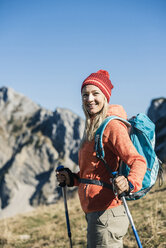 Austria, Tyrol, smiling woman on a hiking trip in the mountains - UUF16409