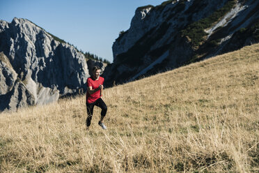 Austria, Tyrol, man running in the mountains - UUF16413