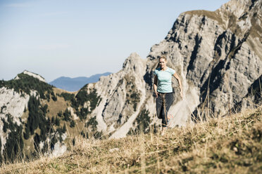 Austria, Tyrol, woman running in the mountains - UUF16417