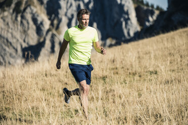 Austria, Tyrol, man running in the mountains - UUF16422