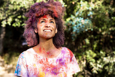 Woman full of colorful powder paint, celebrating Holi, Festival of Colors - ERRF00469