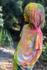 Boy full of colorful powder paint, celebrating Holi, Festival of Colors - ERRF00496