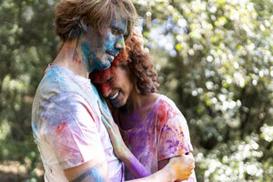 Affectionate couple celebrating Holi, Festival of Colors - ERRF00513